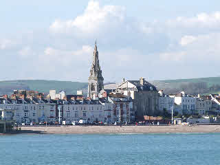 Weymouth seafront past the old pier showing pretty row on Weymouth beach guesthouses